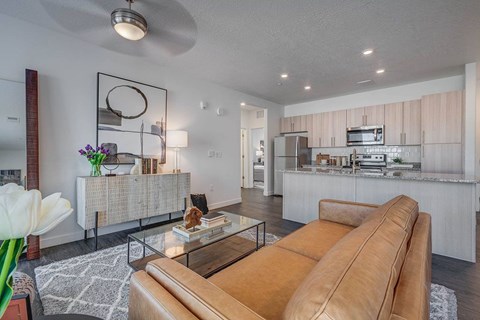 A living room with a brown leather couch and a coffee table.