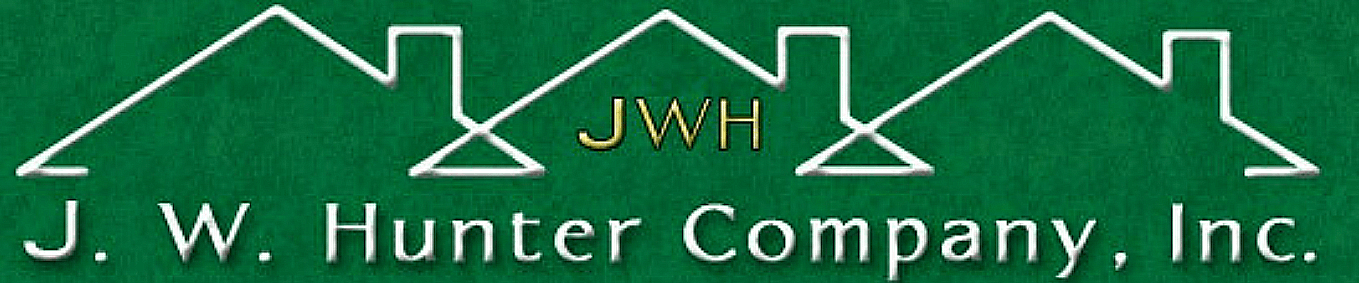 a green sign with the words and j hurt company