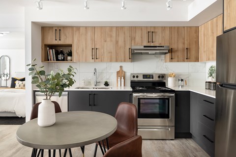 A modern kitchen with a table and chairs.