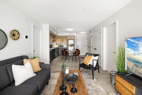 A living room with a grey couch and a wooden coffee table.