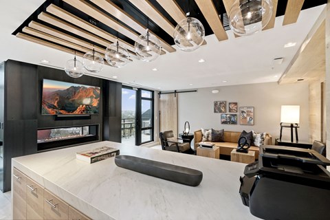 a large living room with a kitchen and a television