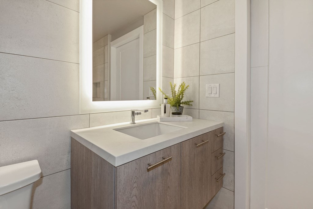 Spa inspired bathroom with backlit mirrors