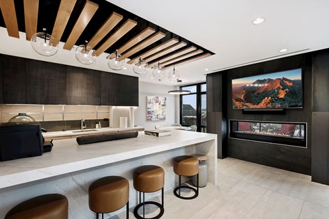 a kitchen with a long counter and a fireplace