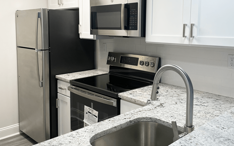 a kitchen with stainless steel appliances and granite counter tops
