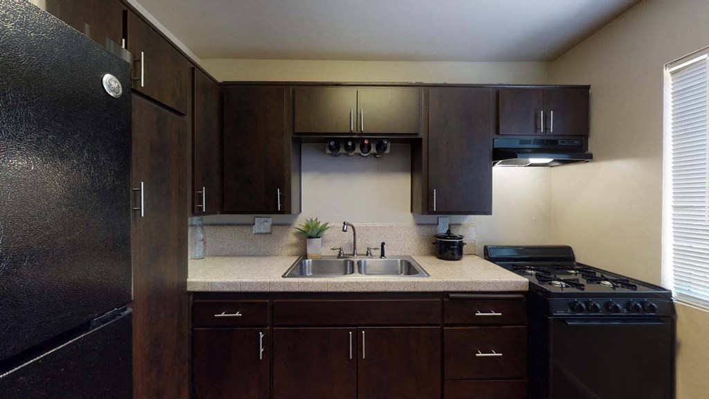 a kitchen with a sink and a stove at The Marquee Apartments, North Hollywood, California