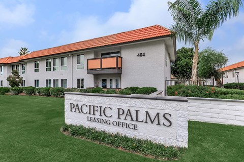 A building with a sign that says Pacific Palms Leasing Office.