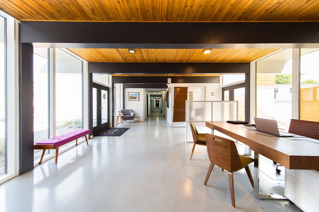 Empty brown wooden table with chairs in community room