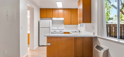 A kitchen with wooden cabinets and a white countertop.