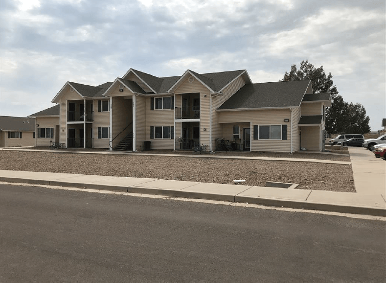 a large apartment building with a street in front of it