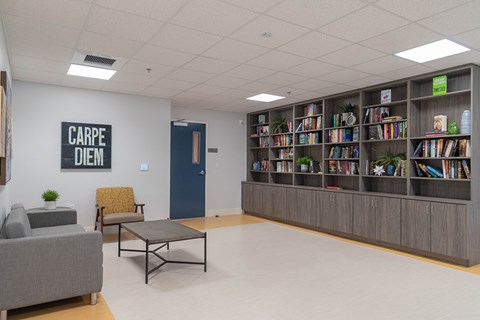 A library with a sign that says "Carpe Diem" on the wall.