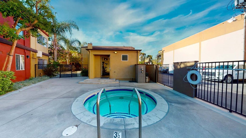 a small pool is in the middle of a house with a fence at The Marquee Apartments, North Hollywood, CA 91605