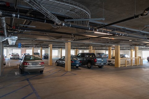 A parking garage with cars parked in it.