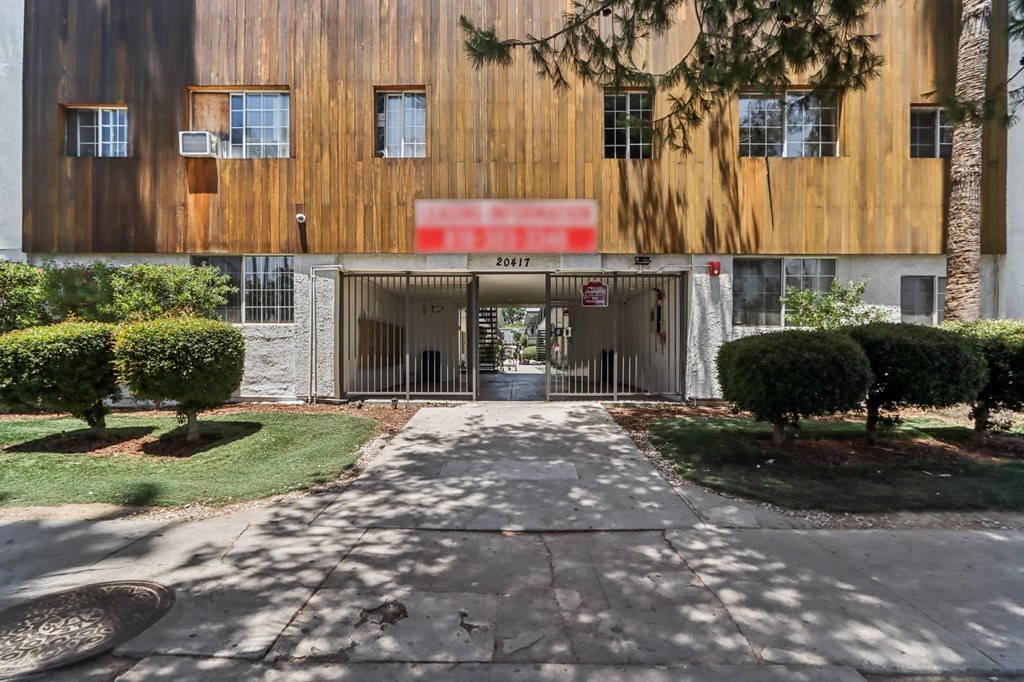 The image shows a building with a red sign that reads "EXIT" in front of it.