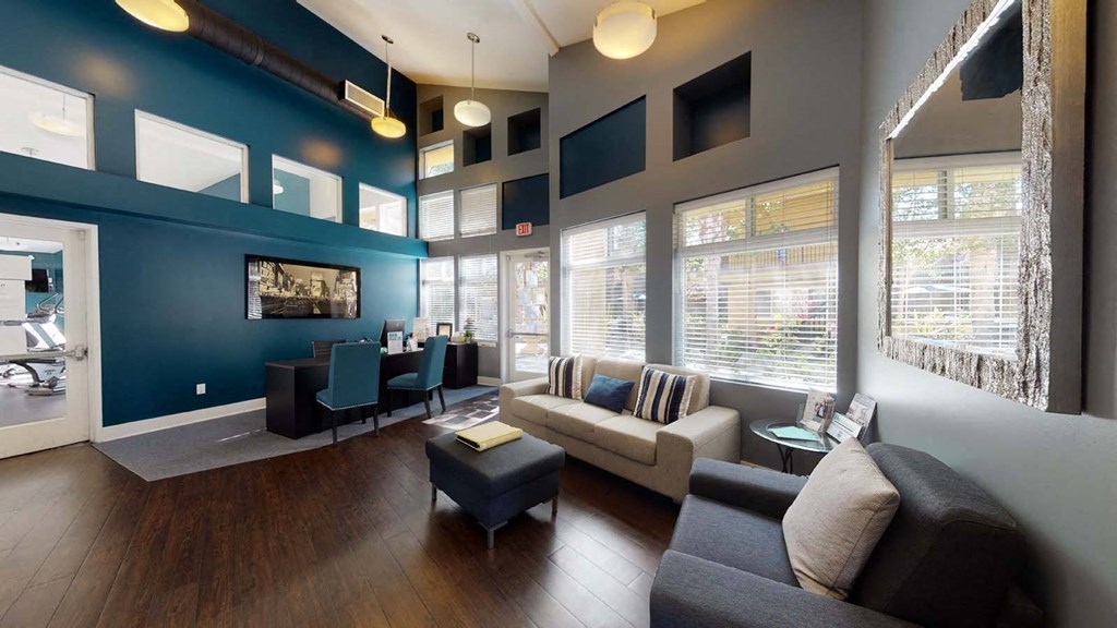 a living room with blue walls and a couch at The Marquee Apartments, California 91605