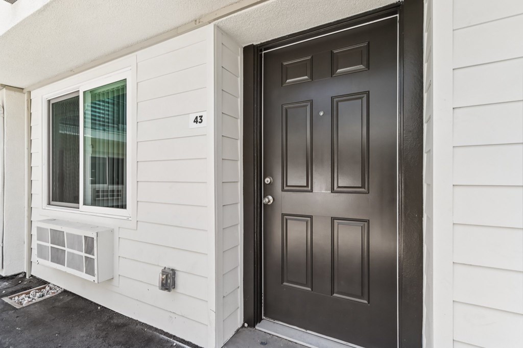 A black door with a number 43 on the wall.