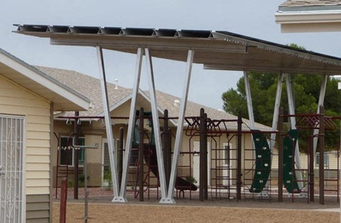 a playground with a swing set and climbing equipment