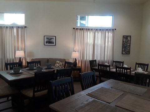 a dining room with tables and chairs and a window