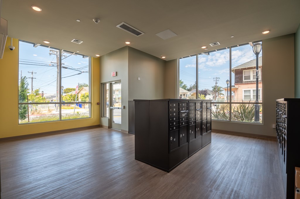 A room with a black cabinet and wooden flooring.