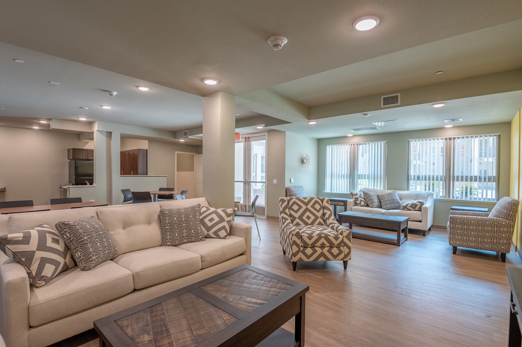 A living room with a couch, chairs, and a coffee table.