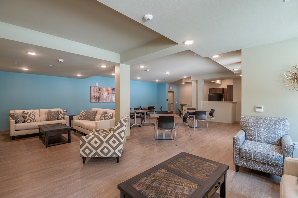 A living room with a couch, chairs, and a coffee table.