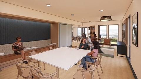 A group of people are sitting around a table in a modern room.
