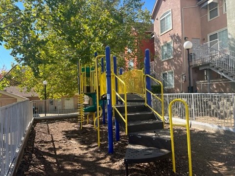 a playground in front of a building with stairs