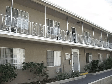 A building with a white door and windows with white frames.