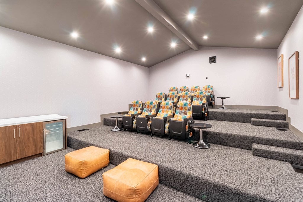 A room with a row of chairs and a speaker on the stage at Chaparral Apartments, Palmdale, CA