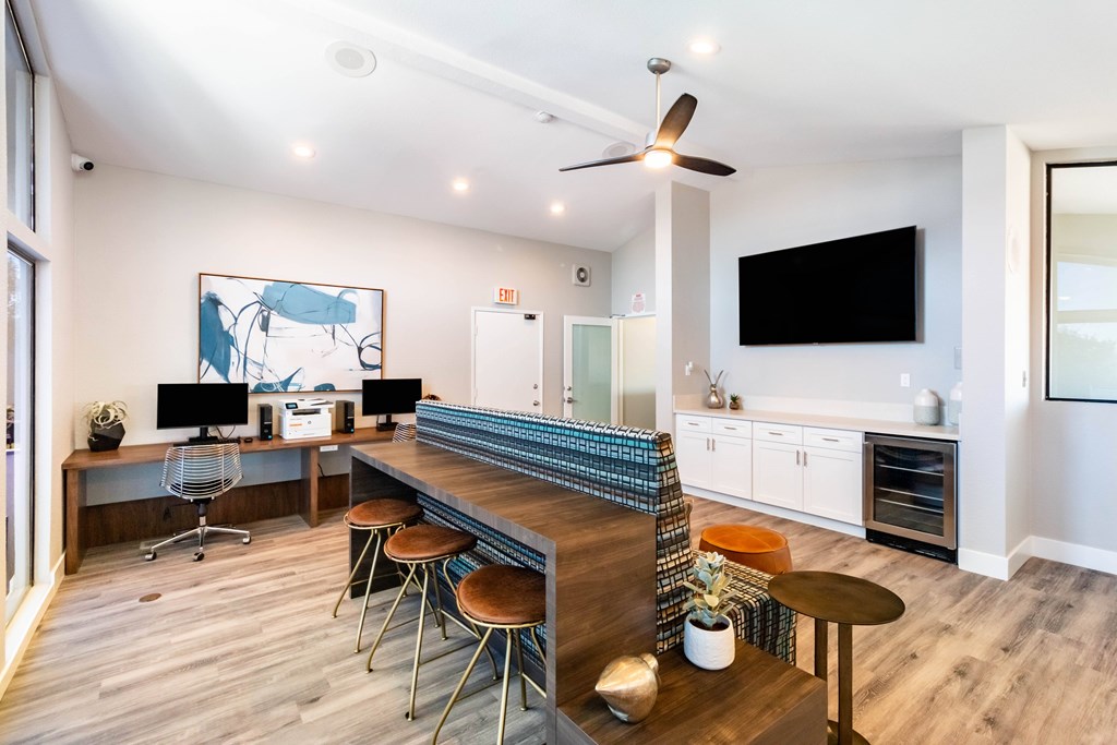 A modern home office with a bar and a television at Chaparral Apartments, California