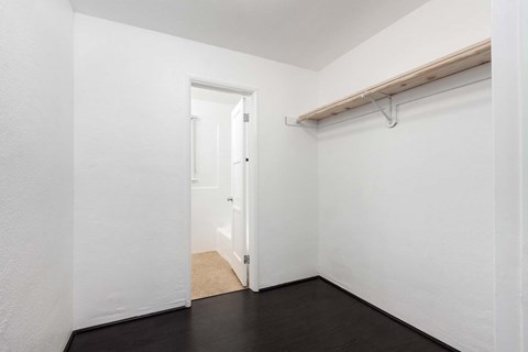 a bedroom with a door to a closet and a sliding door