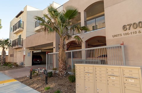 A building with the number 6700 on it and a row of mailboxes in front.