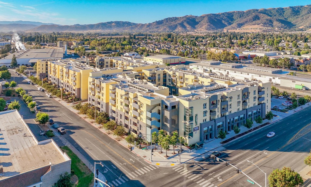 an aerial view of an apartment complex with mountains in the background