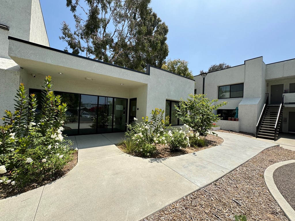 the exterior of the community room with a courtyard in front of it