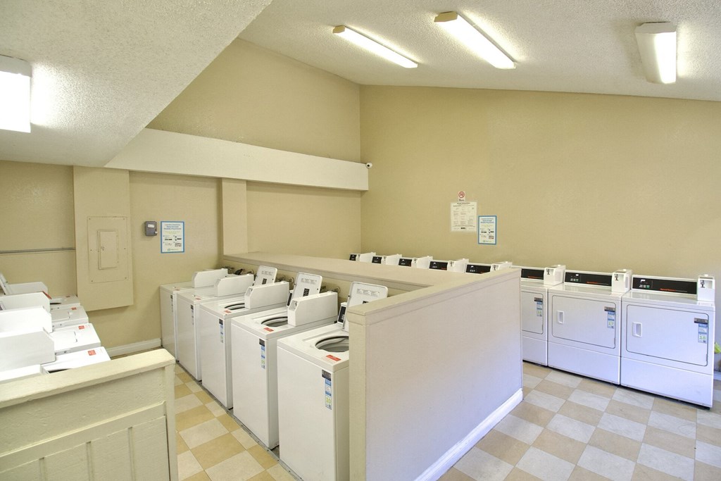 a group of washers and dryers in a laundry room at Brookhollow Apartments, California, 91792