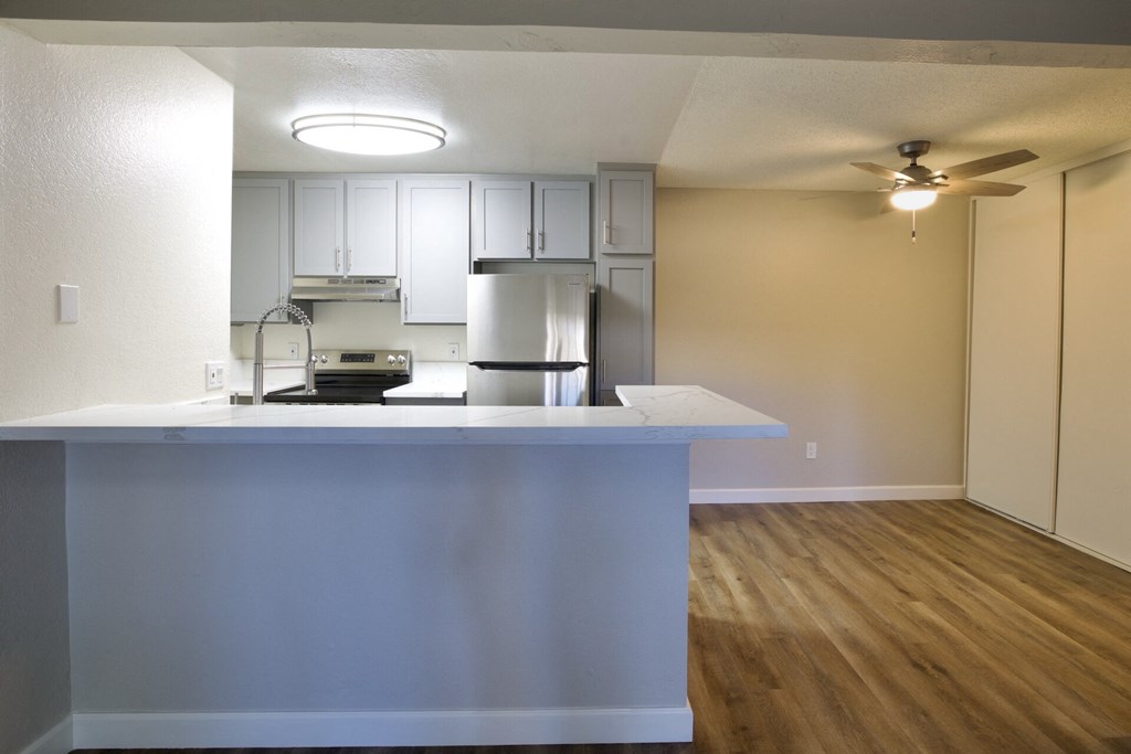 an empty kitchen with a island and a ceiling fan at Brookhollow Apartments, West Covina , California