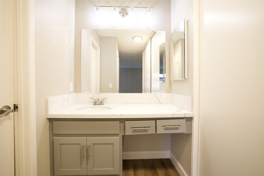 the preserve at ballantyne commons apartment bathroom with sink and mirror at Brookhollow Apartments, West Covina , California
