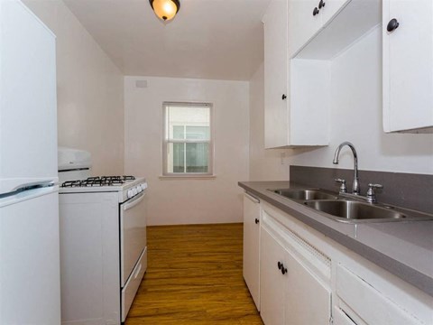 a kitchen with a sink and a stove and a window