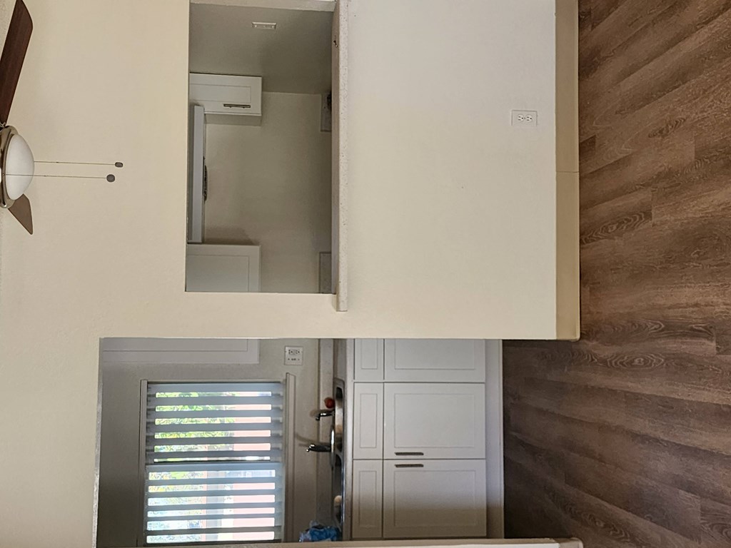 a view of a kitchen with a mirror and a door