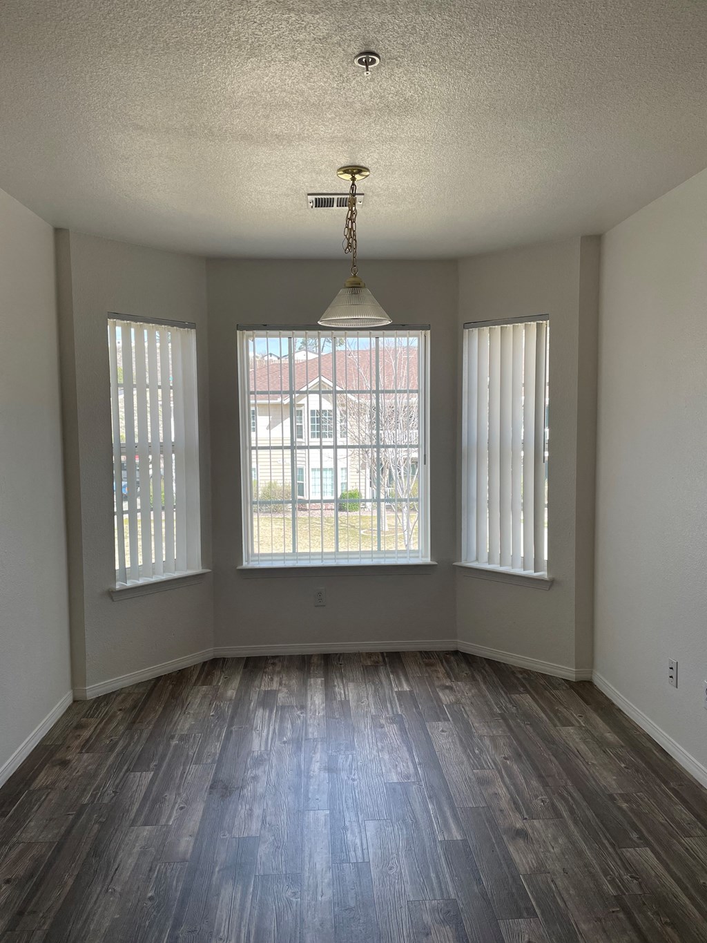an empty living room with a chandelier