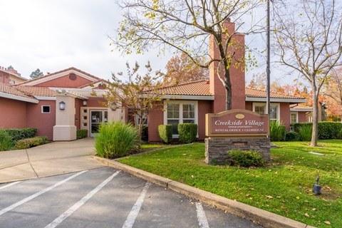 The image shows the front of a building named Creekside Village.