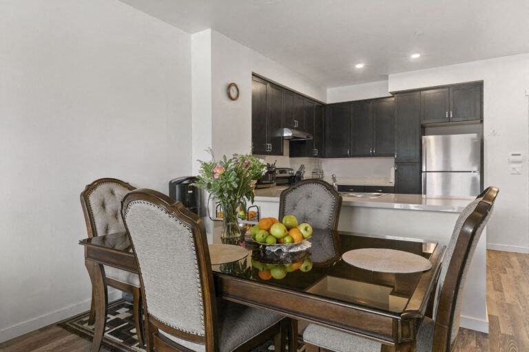 a kitchen and dining room with a table and chairs