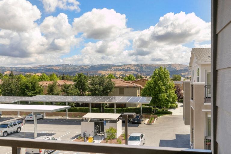 a view of a parking lot from the balcony of a building