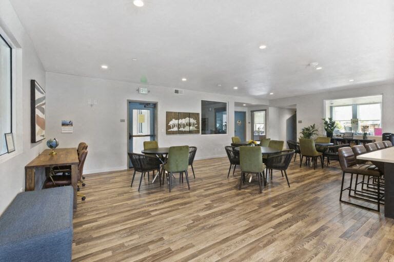 a large living room with tables and chairs