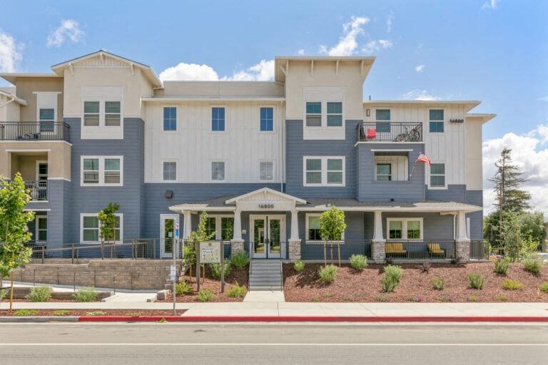 a large apartment building on the side of a street