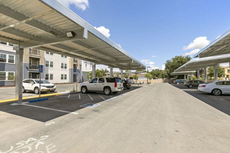 a parking lot with cars parked in front of a building