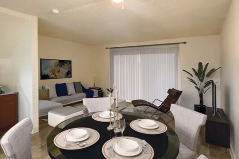 A dining room with a black table set for two.