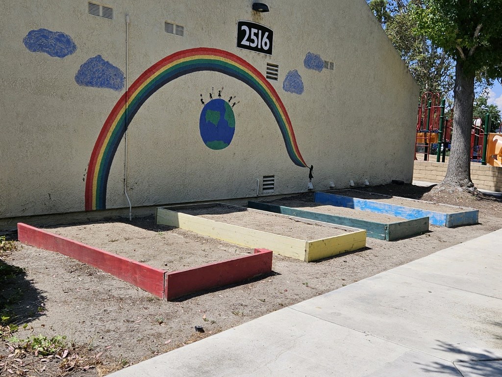 a rainbow painted on the side of a building