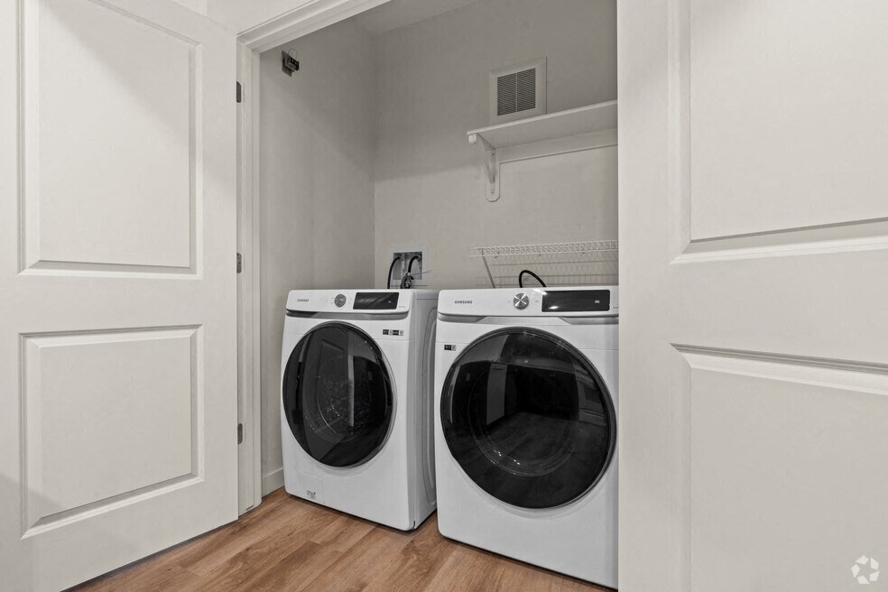 the laundry room in a home with two washing machines