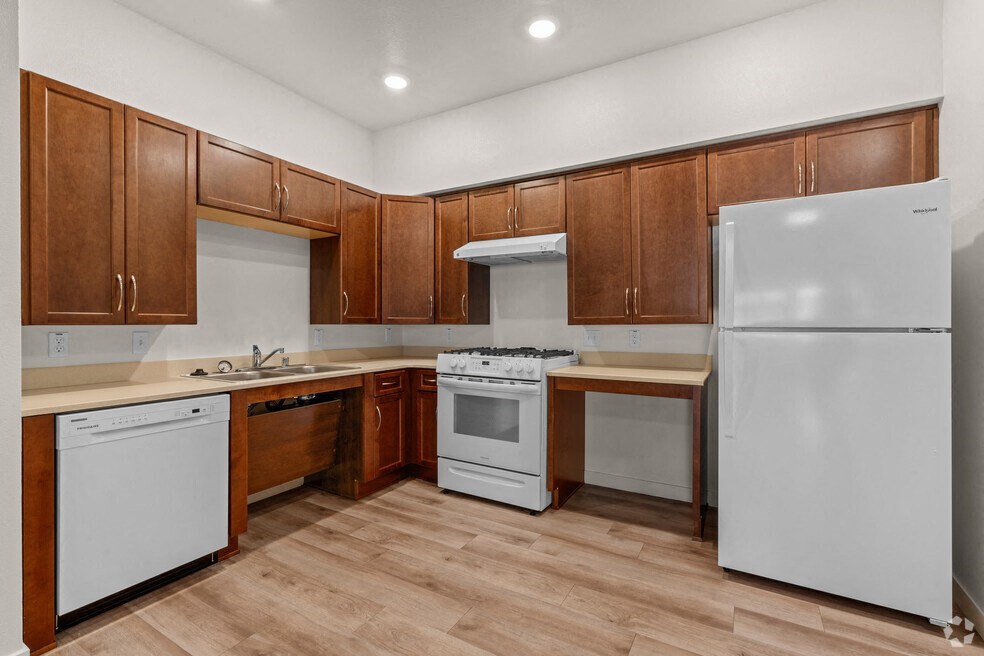 a kitchen with white appliances and wooden cabinets