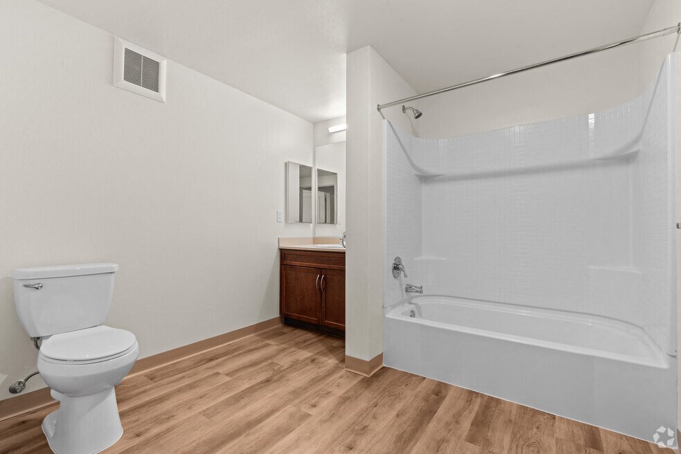 a bathroom with a toilet and a tub and a sink